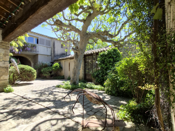 Interior of an old farmhouse with a landscaped garden and a swimming pool, in Maubec.