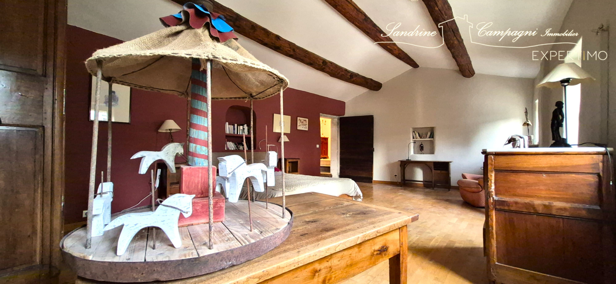 Room with wooden carousel Interior of a bedroom with a wooden carousel and exposed beams.
