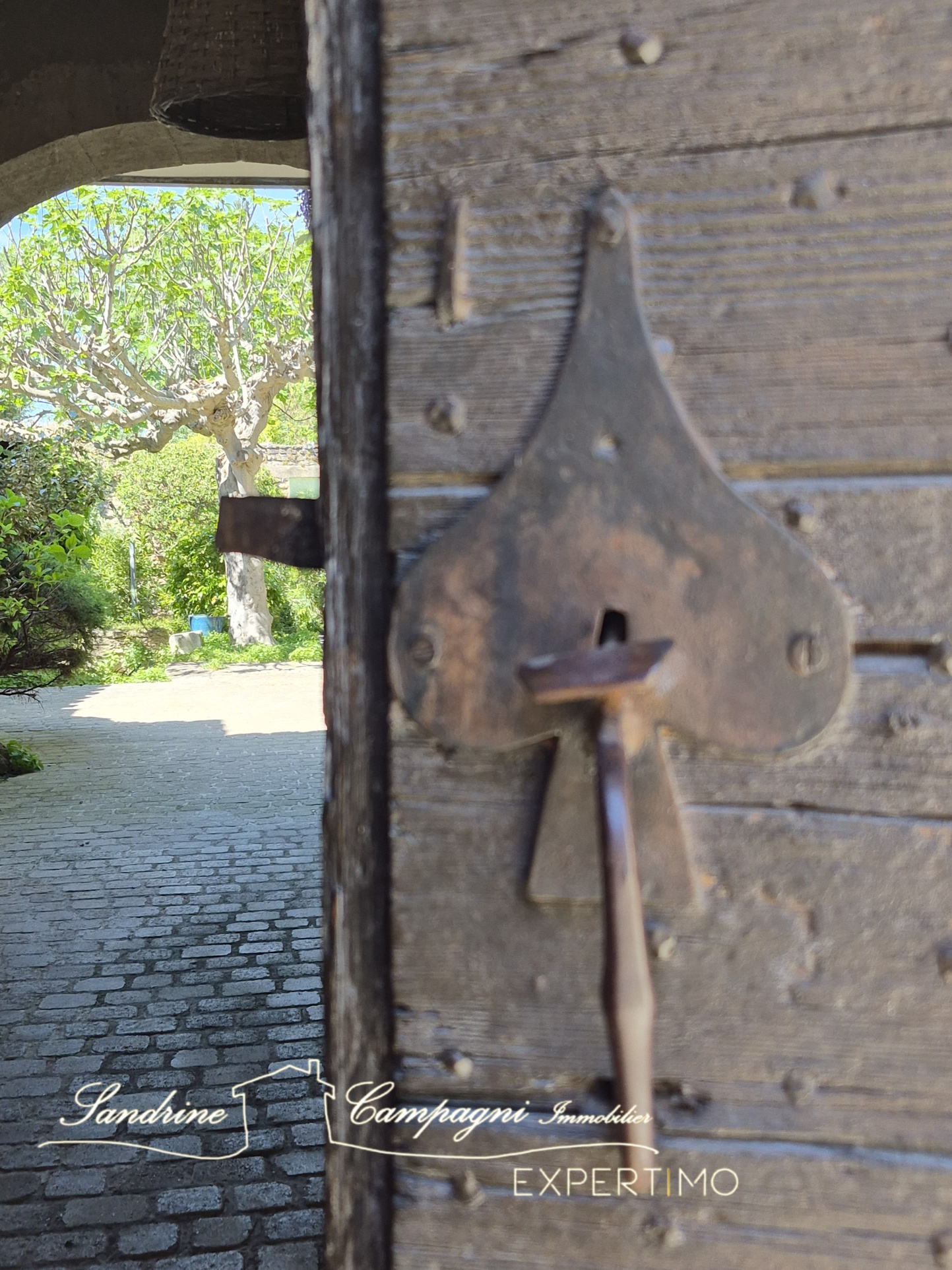 Metal lock on a wooden door Close-up of a heart-shaped metal lock on a wooden door.