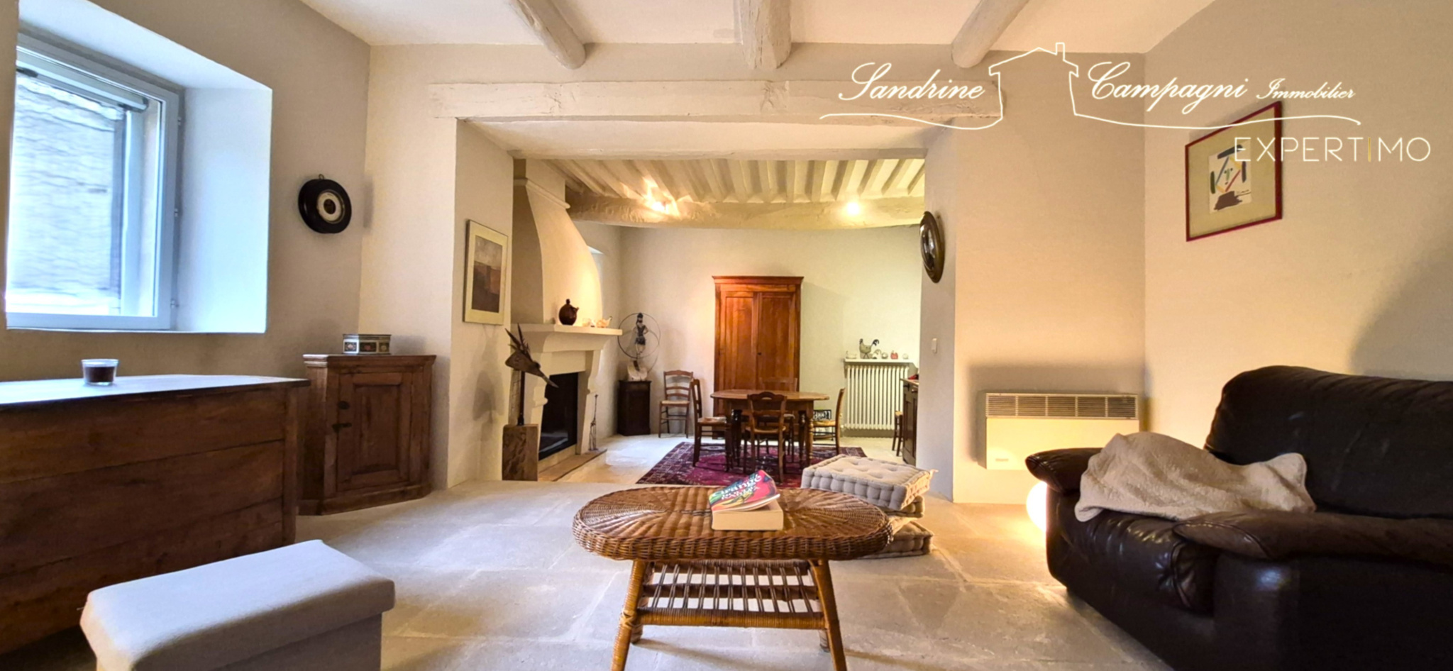 Interior of a farmhouse in Maubec Interior of a restored farmhouse with living room, fireplace and wooden furniture.
