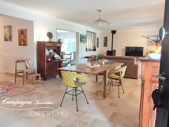 Interior of a renovated house with dining room and living room, modern and bright decor.