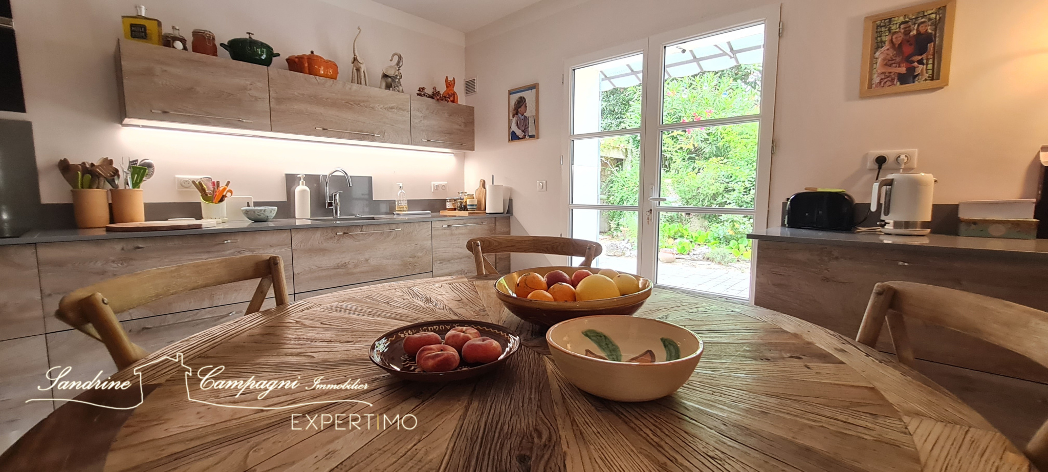 Modern and bright kitchen Interior of a modern kitchen with a wooden table and fruit, natural light