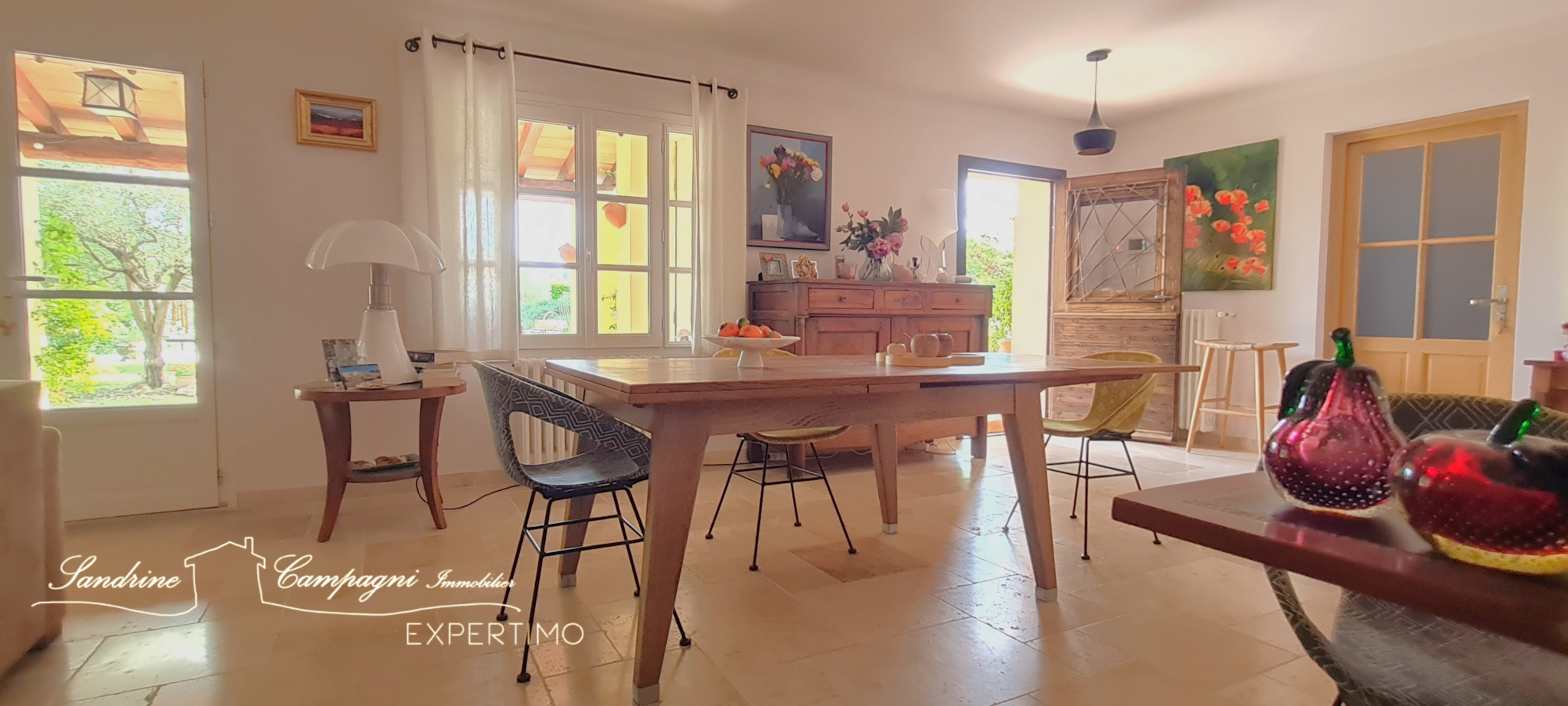 Interior of a renovated house Interior of a renovated house with a wooden table and modern chairs, abundant natural light.