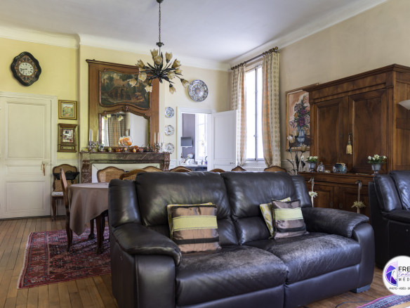 Interior of a bourgeois house with living room and dining room, wooden furniture and classic decoration.