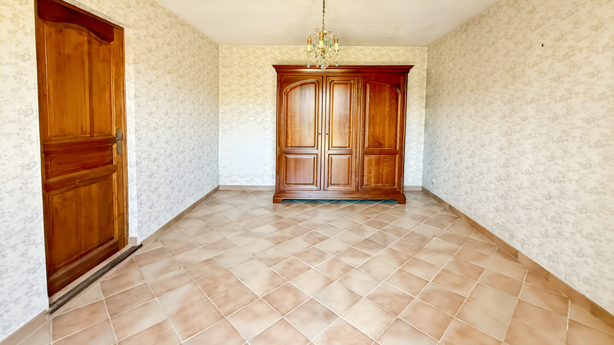 Interior of a property in Tourrettes-sur-Loup with tiled floor and wooden furniture.