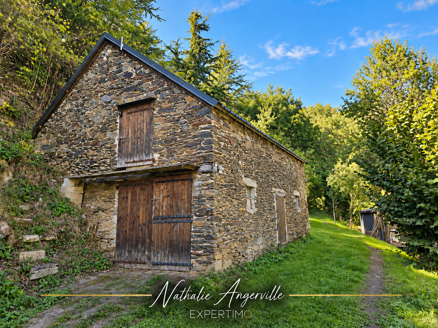 Ancien moulin du XVe siècle à Cassagnes-Bégonhès Ancien moulin en pierre réhabilité, situé dans une vallée aveyronnaise, entouré de verdure.