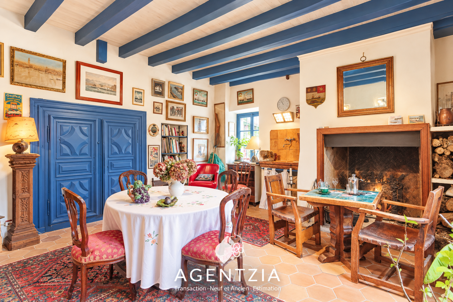 Interior of a Labourdine house in Cambo-les-Bains, with a dining table and a sitting area.