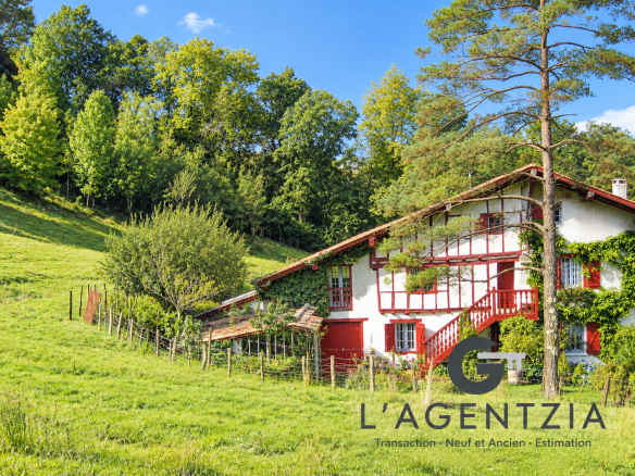 Labourdine half-timbered farmhouse surrounded by greenery in Cambo-les-Bains.