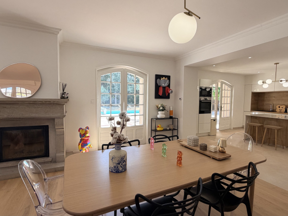 Interior of a renovated house with living room, fireplace and open kitchen in Saint-Just-Saint-Rambert.