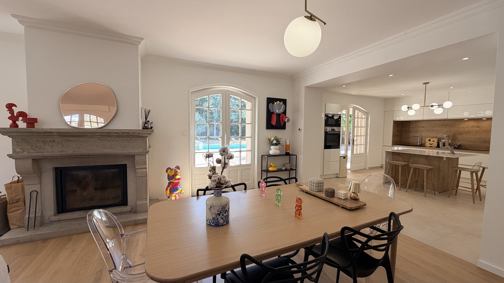 Interior of a renovated house with living room, fireplace and open kitchen in Saint-Just-Saint-Rambert.