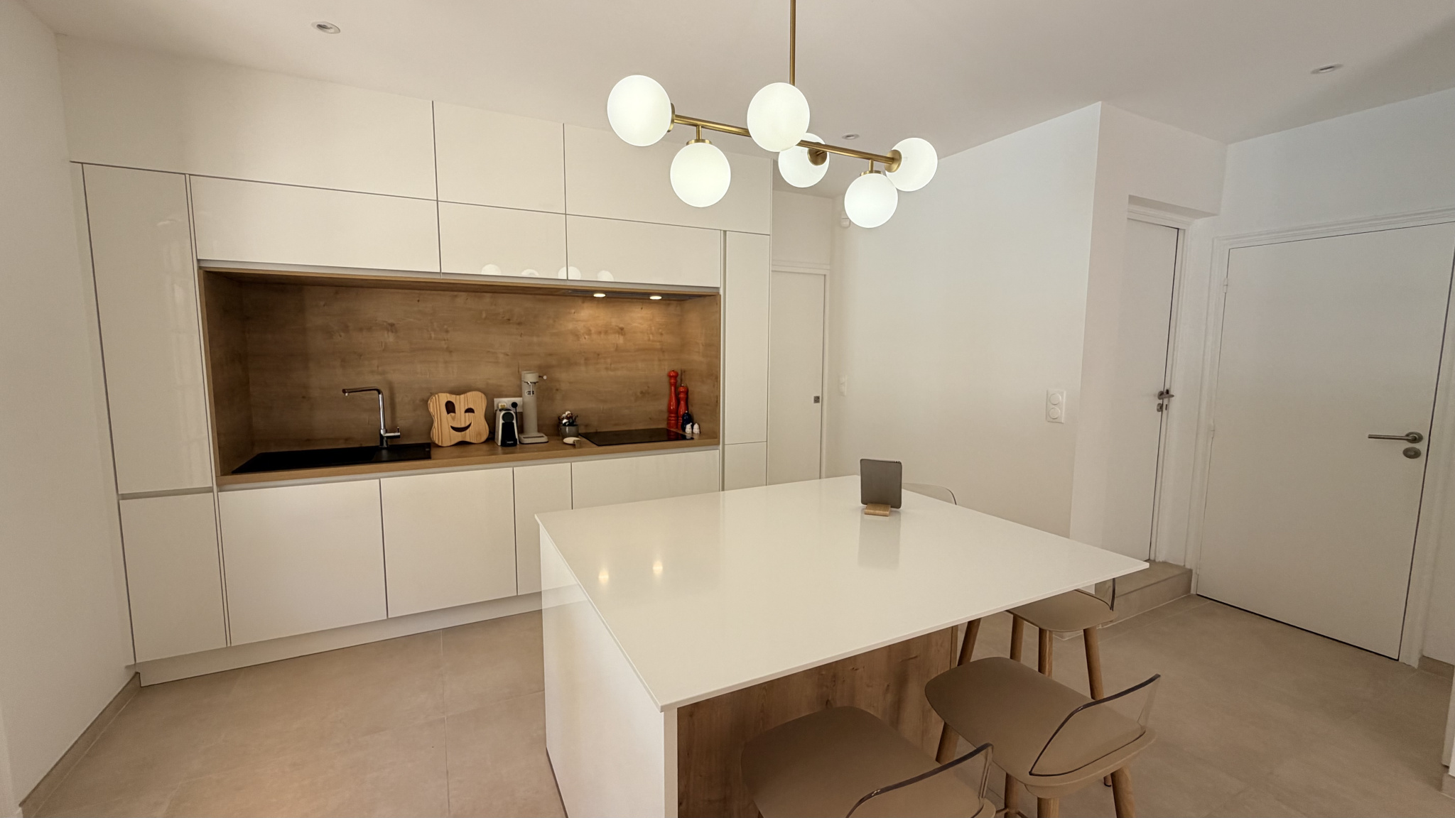 Modern and bright kitchen with a central island and white furniture.
