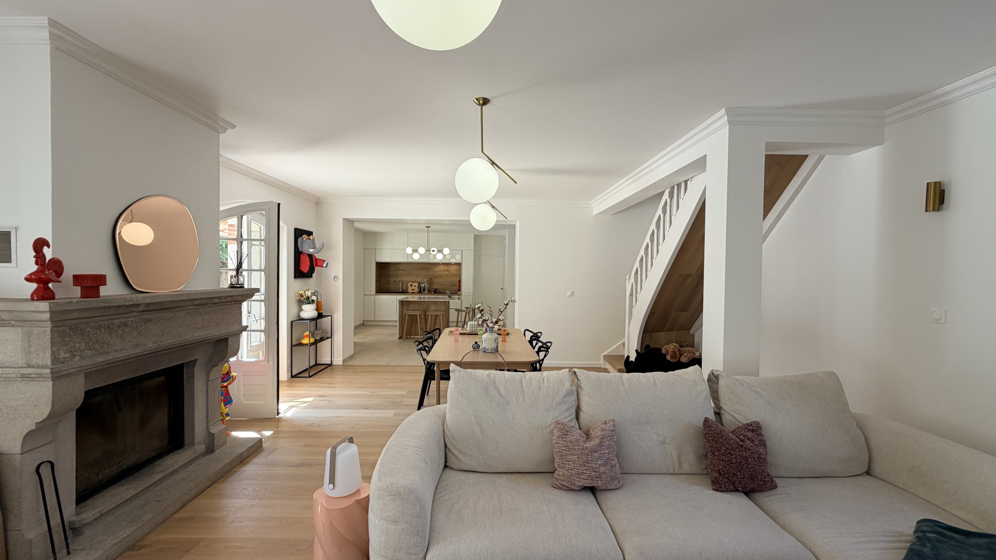 Interior of a renovated house with living room, fireplace and dining room.