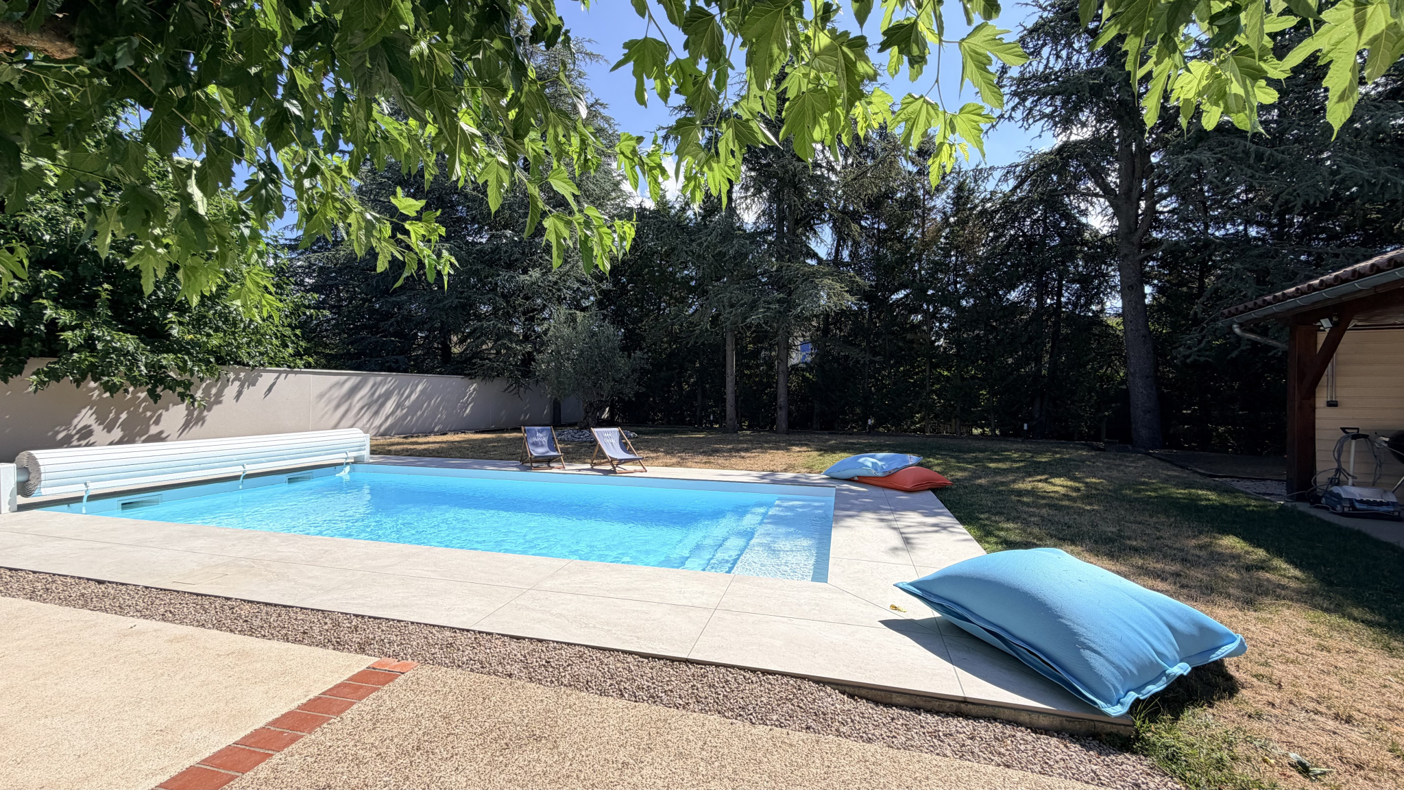 Swimming pool with sun loungers and garden in a house in Saint-Just-Saint-Rambert.