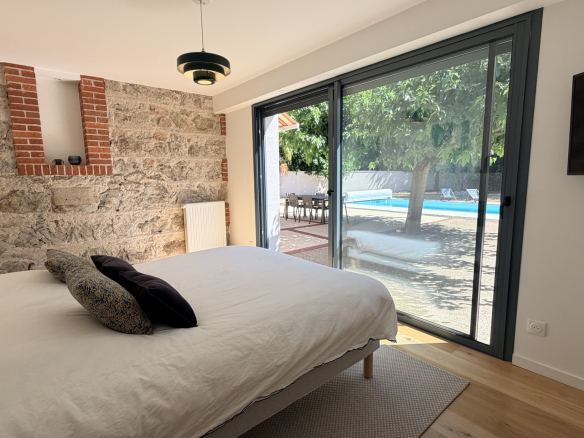 Room in a renovated house with a view of the swimming pool in Saint-Just-Saint-Rambert.