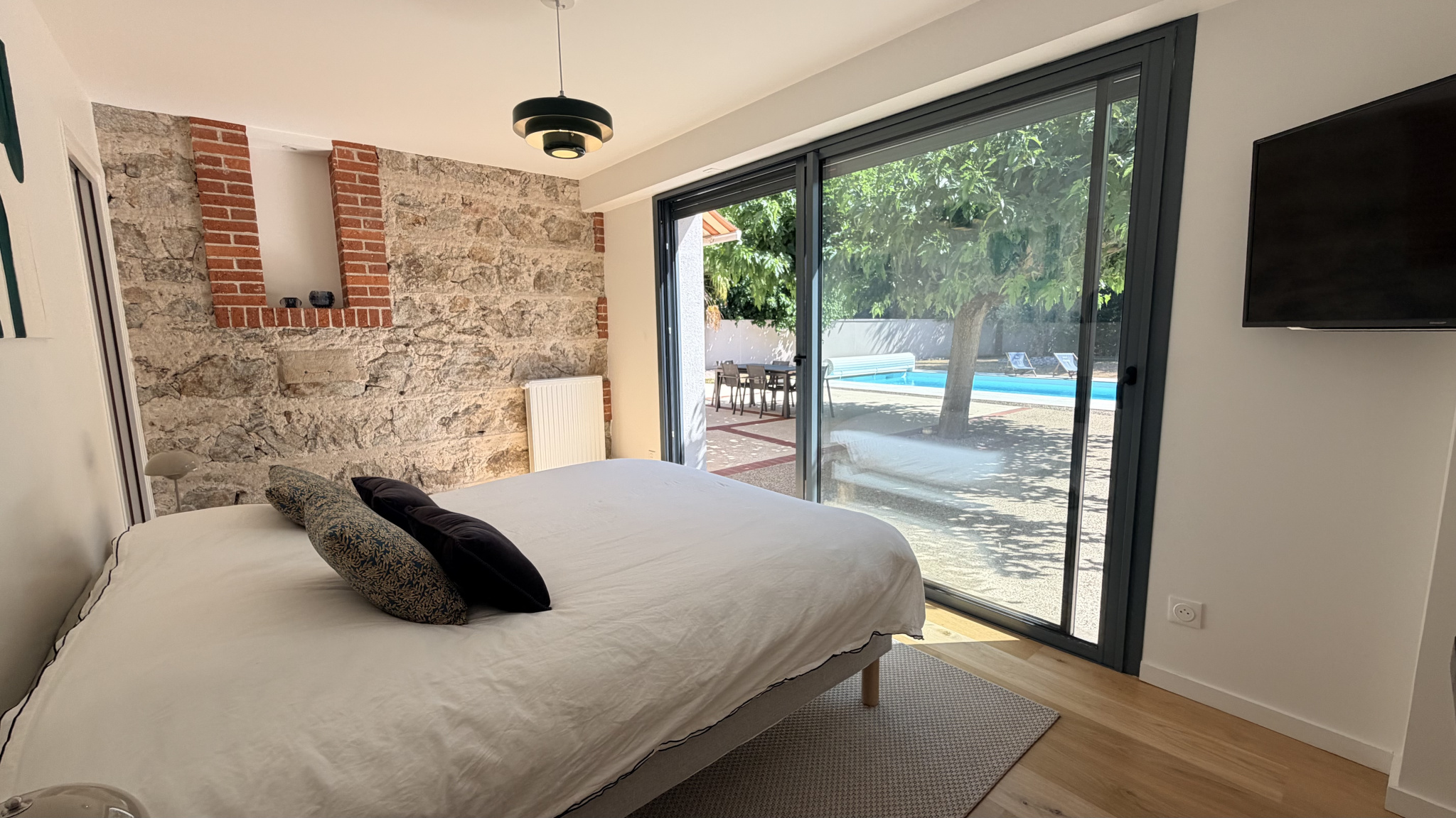 Room in a renovated house with a view of the swimming pool in Saint-Just-Saint-Rambert.