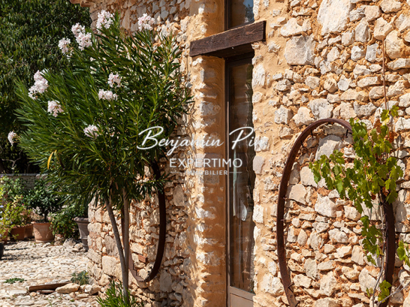 Renovated stone house with garden and swimming pool in Villars, surrounded by greenery.