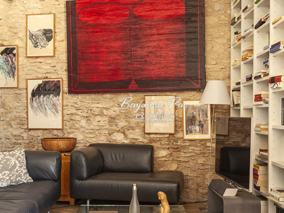 Interior of a stone house with a modern living room, stone walls and artwork.