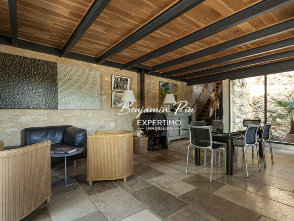 Interior of a renovated stone house with modern furniture and natural light in Villars.