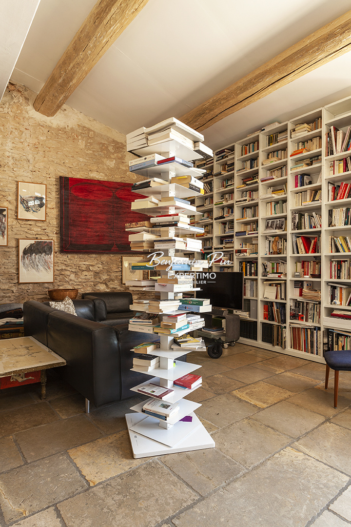 Interior of a house in Villars Interior of a house in Villars with a modern library and stone walls.