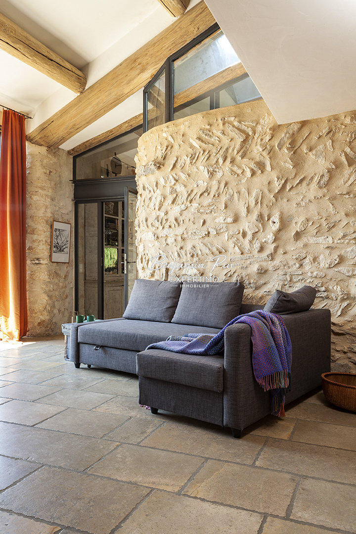 Interior of a stone house in Villars Interior of a renovated stone house with a sofa in a bright living room.