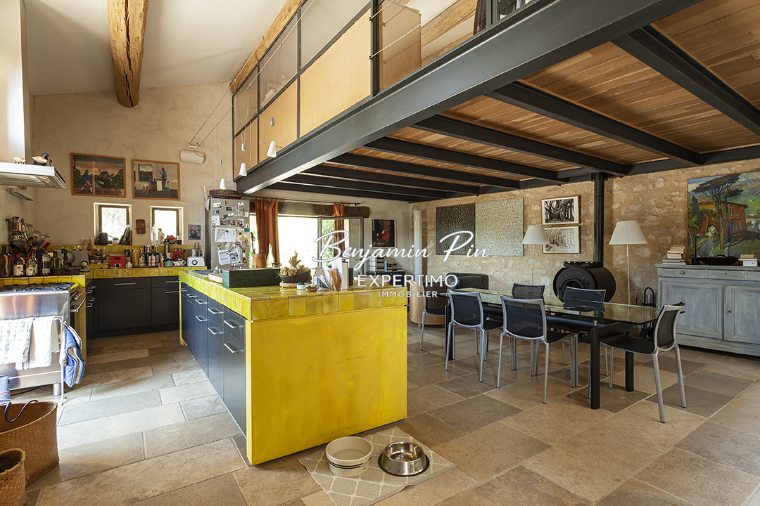 Interior of a house in Villars Interior of a renovated stone house with a modern kitchen and dining area.