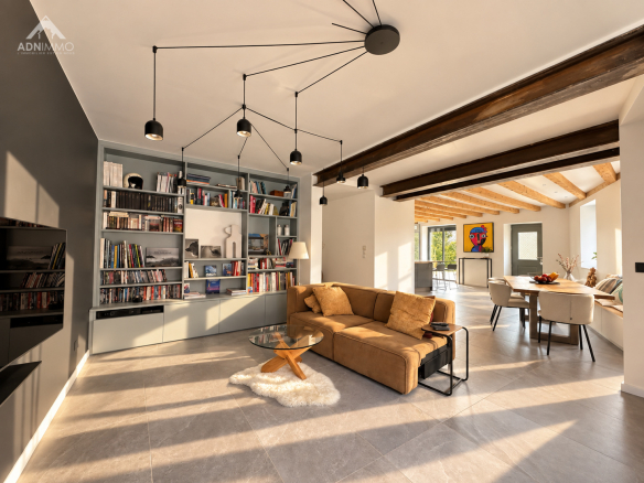 Intérieur d'une maison rénovée avec un salon lumineux et moderne, murs clairs et meubles contemporains.