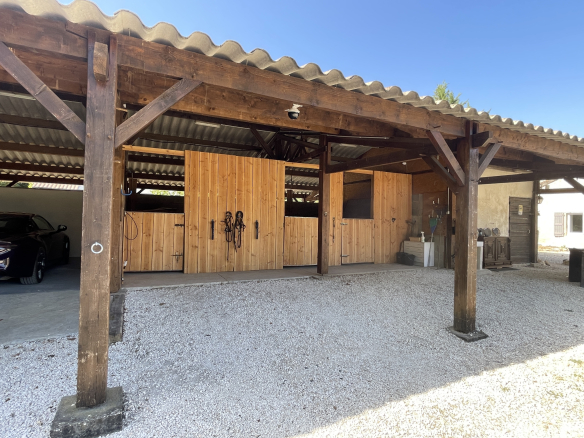 Wooden outbuildings with horse stalls on an estate in Lot-et-Garonne