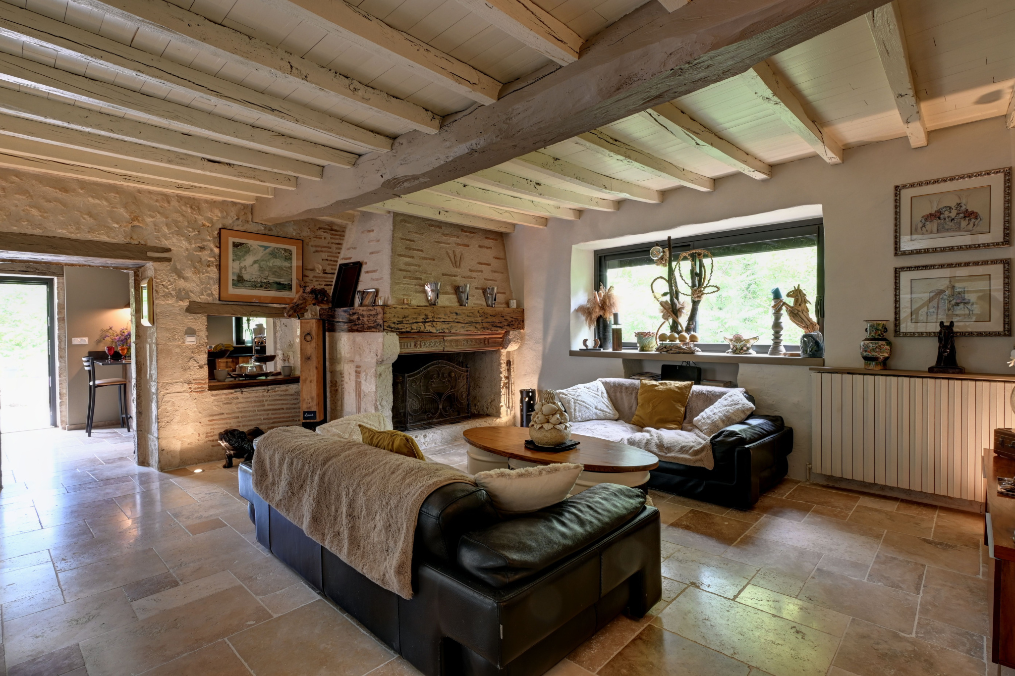 Living room of a prestigious house Interior of a house with a comfortable living room, leather sofa and stone fireplace.
