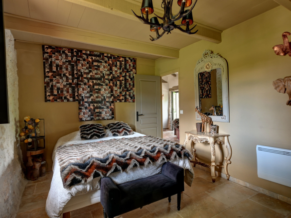 Guest house bedroom with elegant decor and comfortable bed.