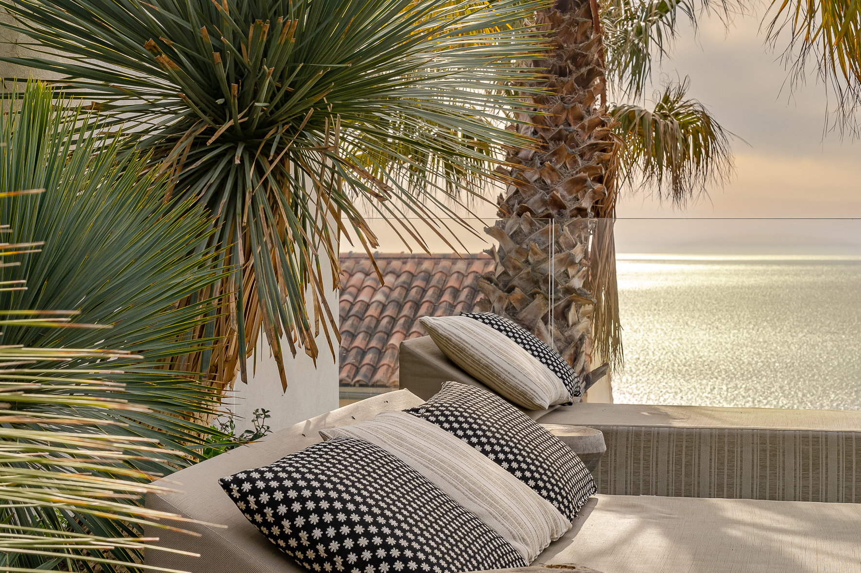 Terrace with sea view in Marseille Terrace of a villa with sea view, plants and decorative cushions.