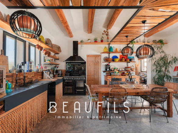 Interior of a Mediterranean villa with open kitchen and dining room, bohemian chic decor.