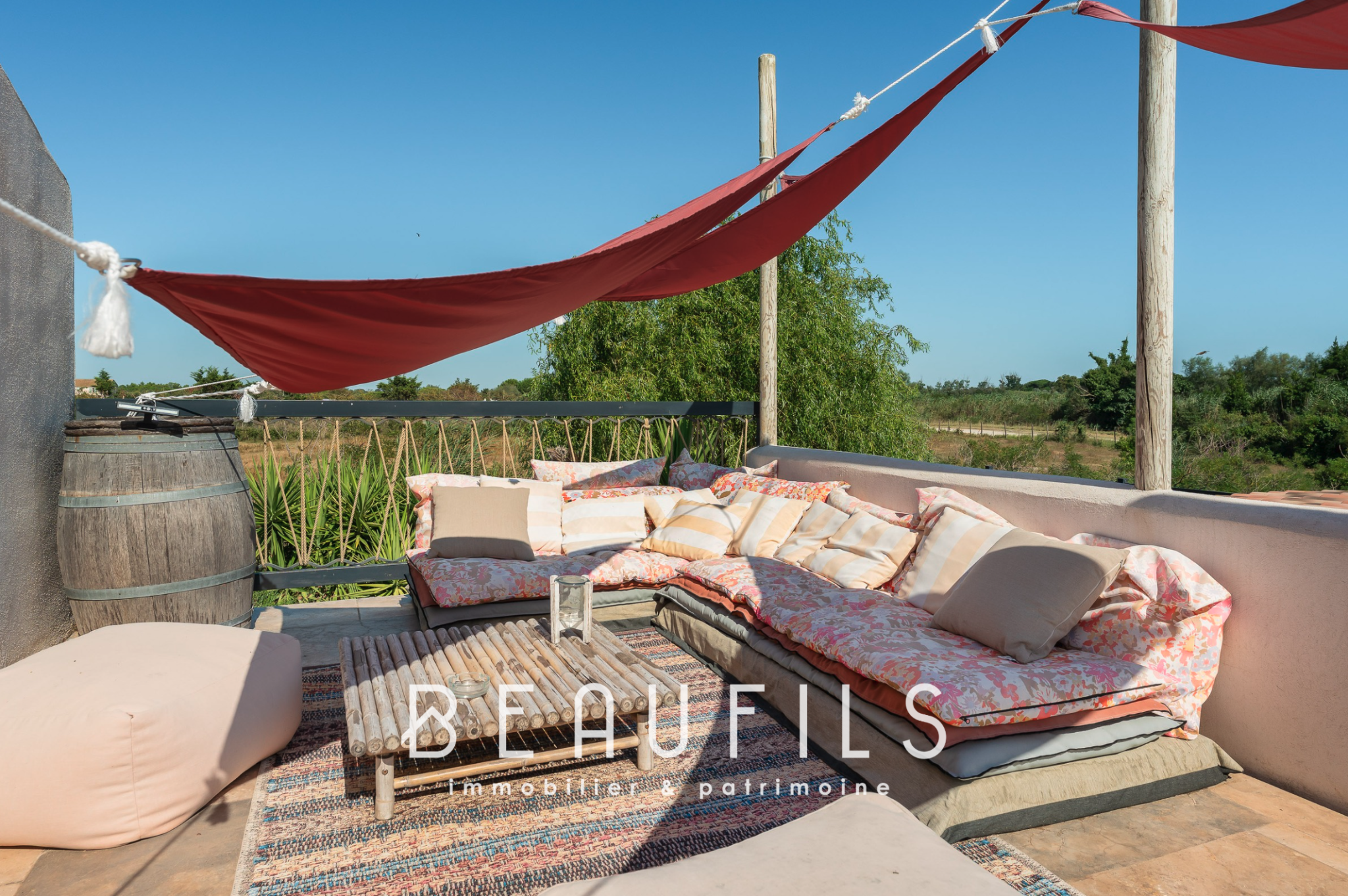 Mediterranean villa terrace Terrace of a Mediterranean villa with cushions and sails, surrounded by nature.
