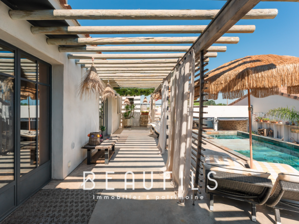 Terrace of a Mediterranean villa with swimming pool and parasols in Saintes Maries de la Mer.