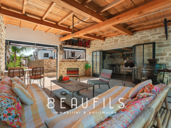 Interior of a Mediterranean villa with living room and open kitchen, bohemian chic decor.