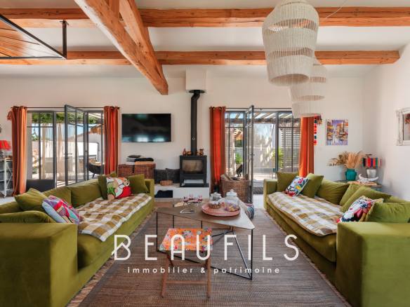 Interior of a Mediterranean villa with green sofas and bohemian chic decor.
