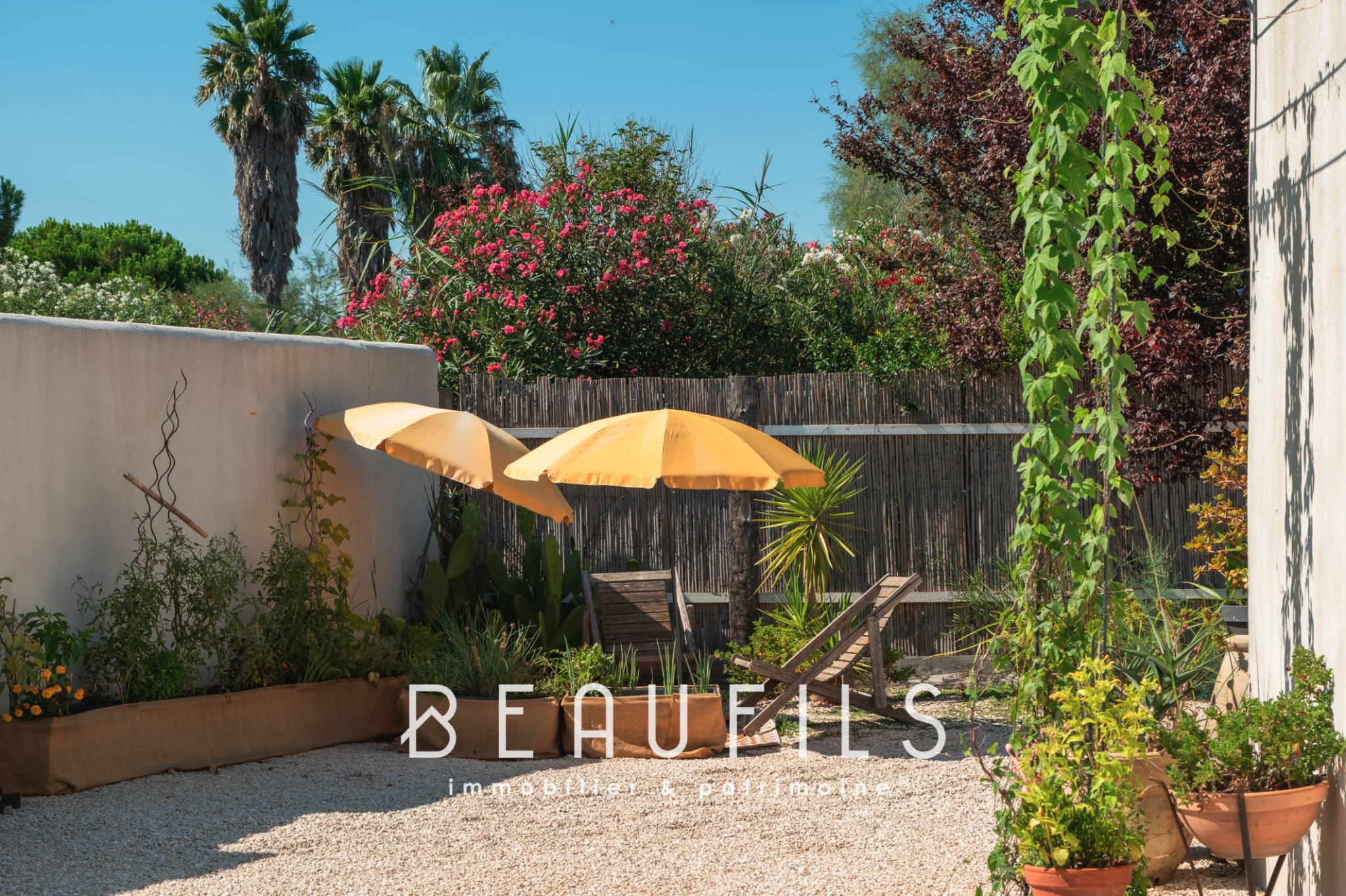 Mediterranean villa terrace Terrace of a Mediterranean villa with sun loungers and parasols in Saintes Maries de la Mer.