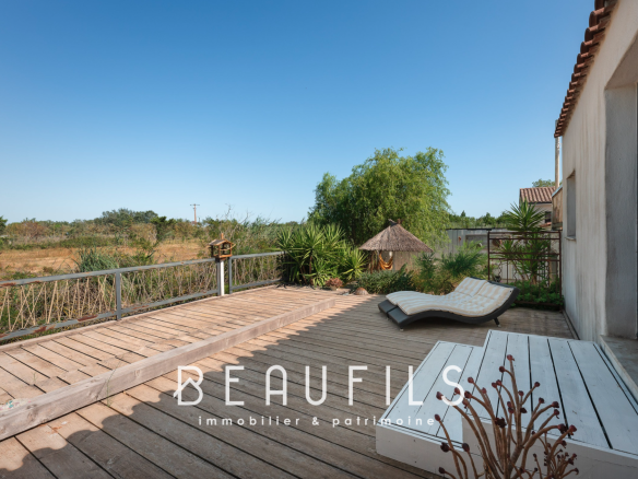 Wooden terrace of a Mediterranean villa with views of nature in Saintes Maries de la Mer.