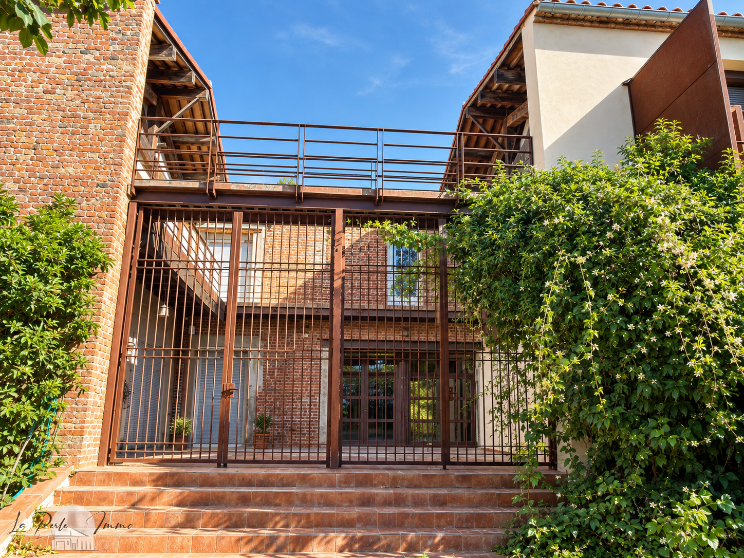 Former wine cellar renovated in Perpignan Entrance to a renovated old wine cellar in Perpignan with brick walls and a modern structure.