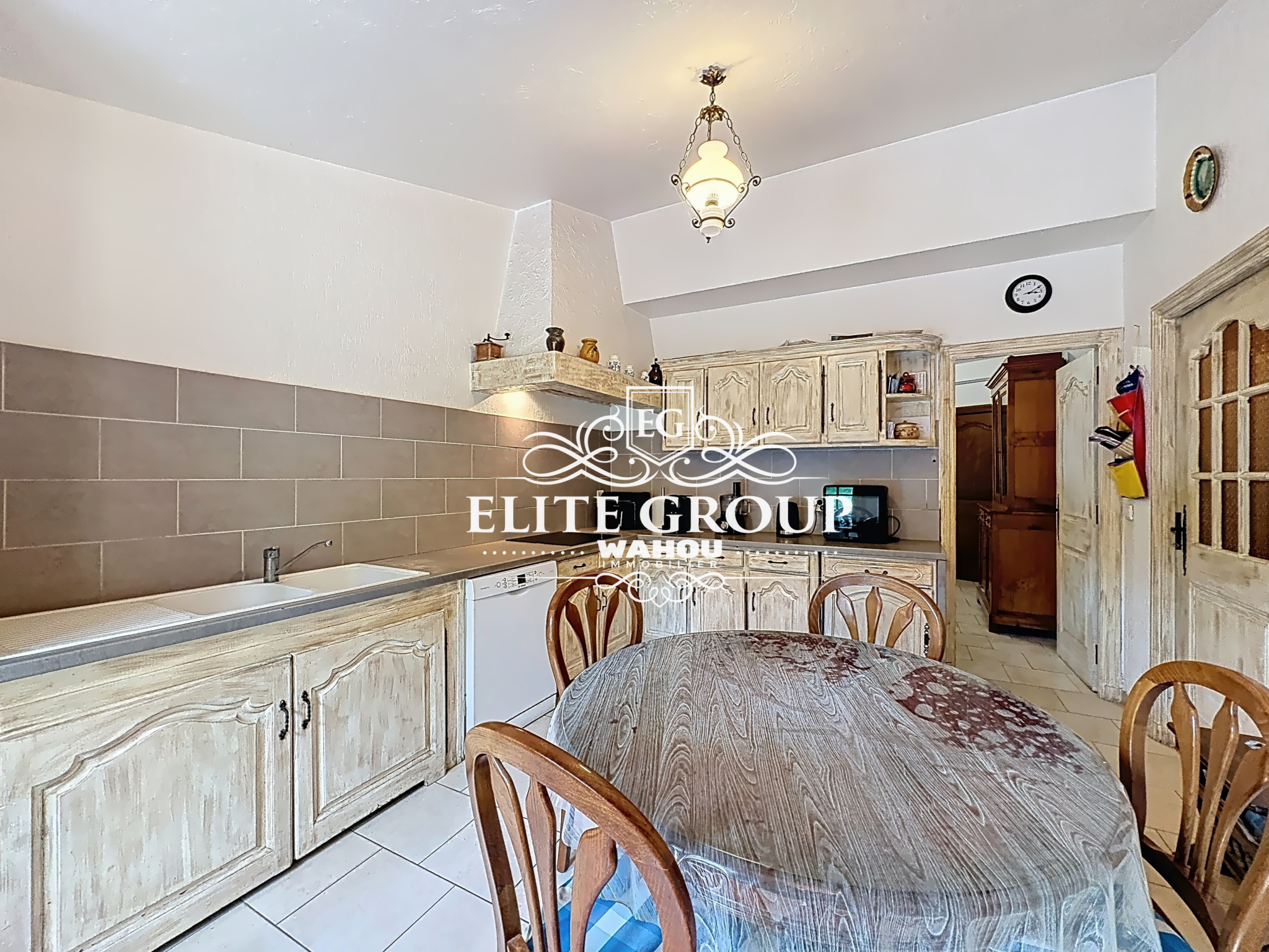Kitchen of a Provençal villa in Mougins with wooden table and chairs.