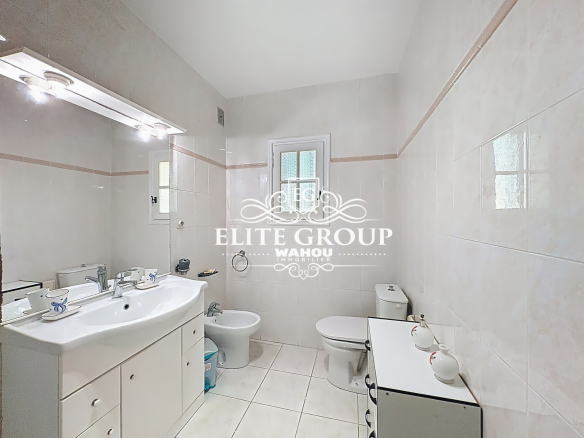Spacious bathroom with sink, shower and toilet, in a villa in Mougins.