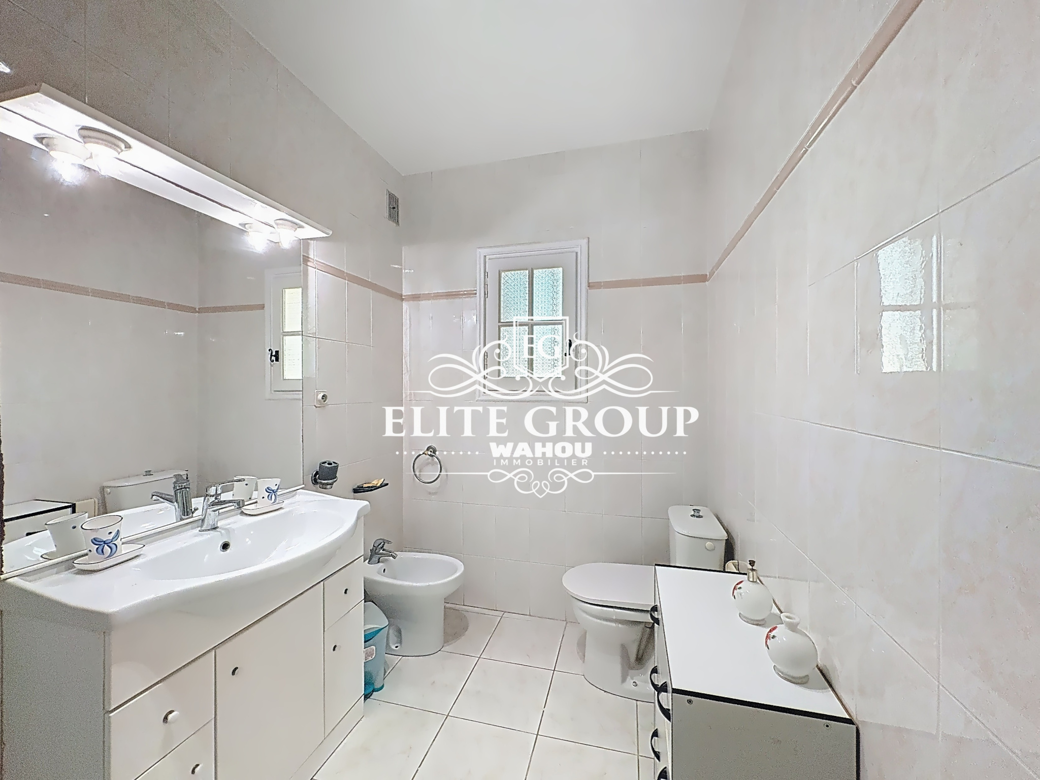 Spacious bathroom with sink, shower and toilet, in a villa in Mougins.