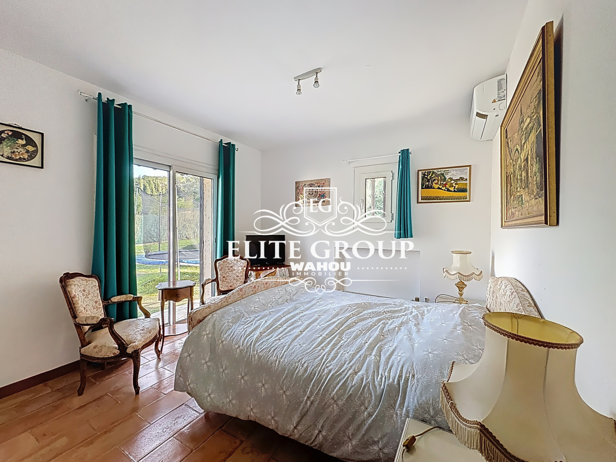 Room in a Provençal villa in Mougins, with bed and antique furniture.