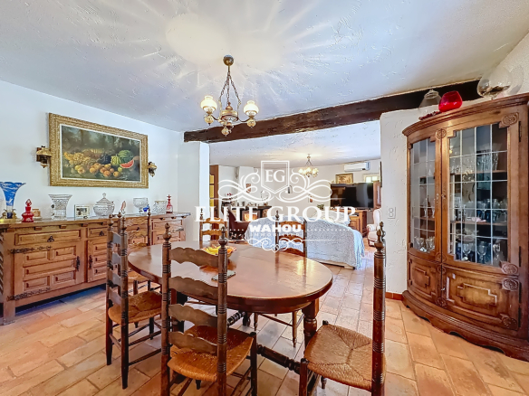 Interior of a Provençal villa with a wooden dining room and elegant decor.