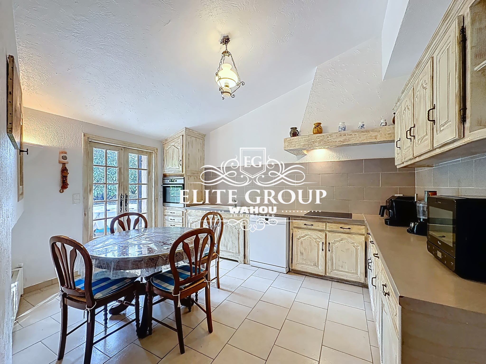 Kitchen of a Provençal villa in Mougins with wooden table and chairs.