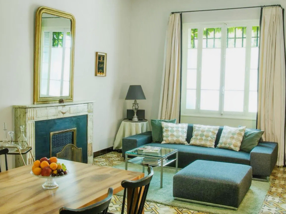 Interior of a renovated bastide with a living room and dining room, L'Isle-sur-la-Sorgue.