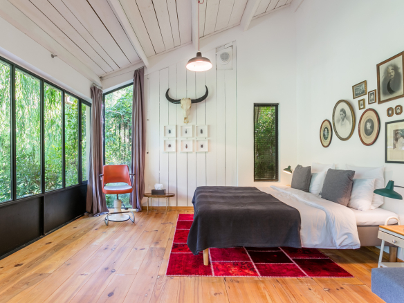Bright room with double bed, modern decor and garden view.