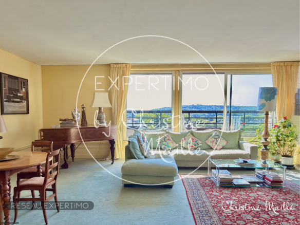 Interior of a rooftop apartment with a bright living room and panoramic views in Versailles.