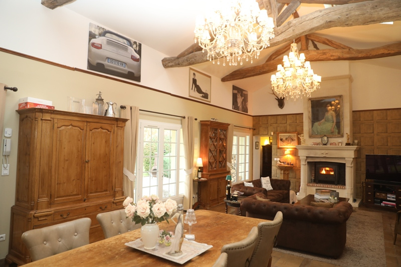 Interior of a luxury home Interior of a house with a large living space, dining table, sofas and fireplace.