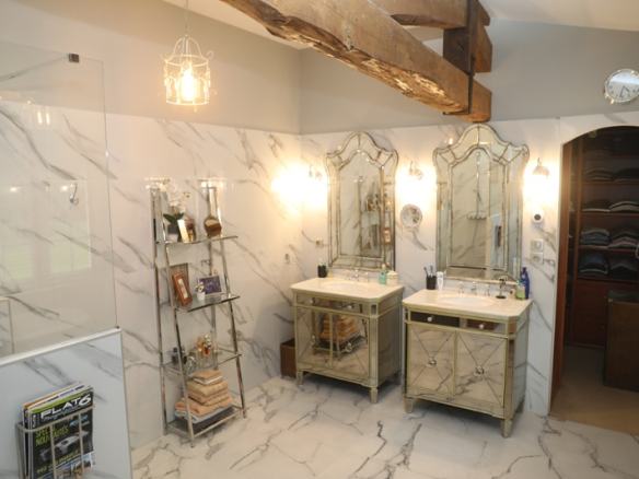 Modern bathroom with two sinks, mirror and marble decor.