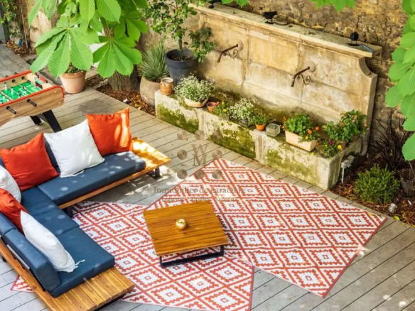 Terrace of a property with sofa, coffee table and plants, L'Isle-sur-la-Sorgue.